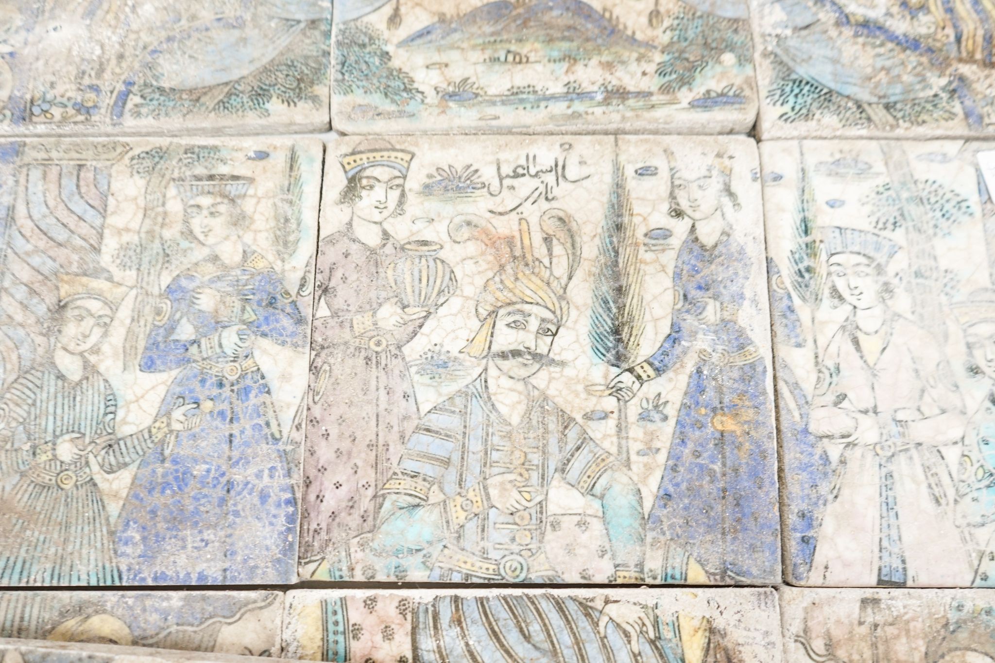 A Persian fritware tile panel, late 19th/early 20th century, incomplete, 55cm wide and another tile fragment